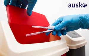 Image of used Syringes being disposed into a bin