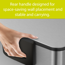 Load image into Gallery viewer, Hand holding a metallic object with text about space-saving wall placement.